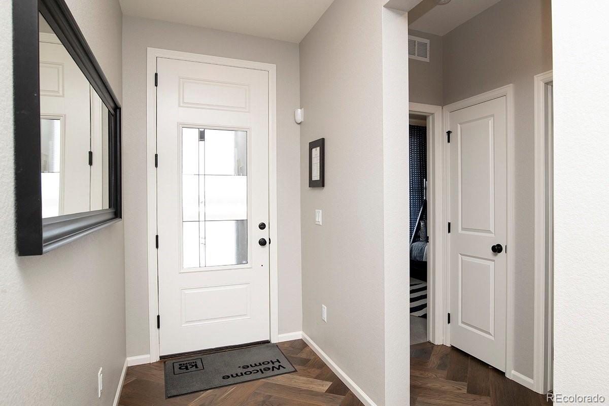 2199 Barela Drive Berthoud, CO 80513 - Photo 3 of 32 a view of a hallway with wooden floor and closet