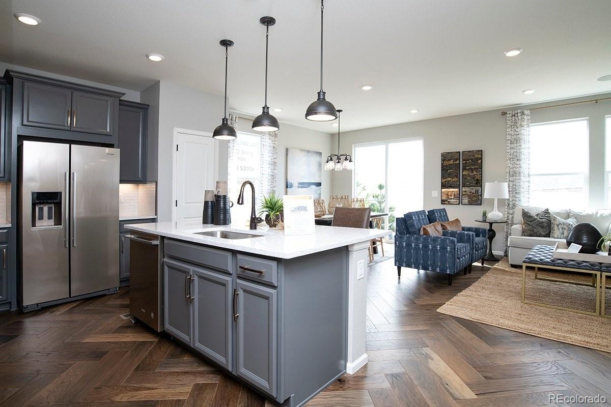 2199 Barela Drive Berthoud, CO 80513 - Photo 7 of 32 a large kitchen with kitchen island a large counter top stainless steel appliances and a large window
