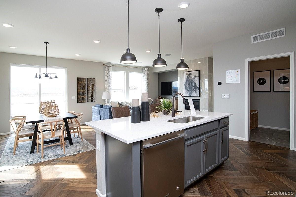 2199 Barela Drive Berthoud, CO 80513 - Photo 10 of 32 a view of kitchen island kitchen island sink stove and living room view