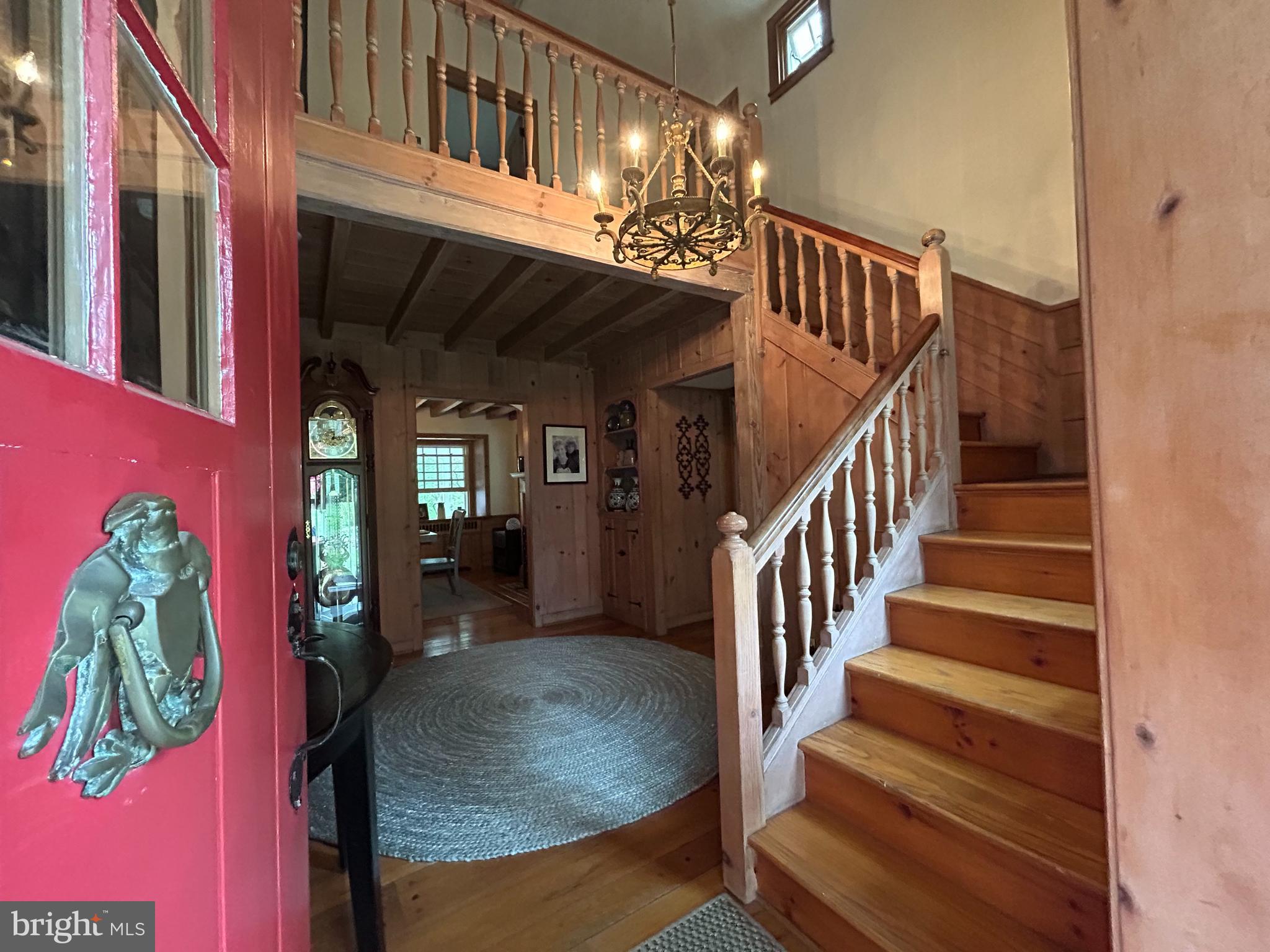 1521 Old Welsh Road Huntingdon Valley, PA 19006 - Photo 27 of 38 a view of staircase with lots of frames on wall and a chandelier