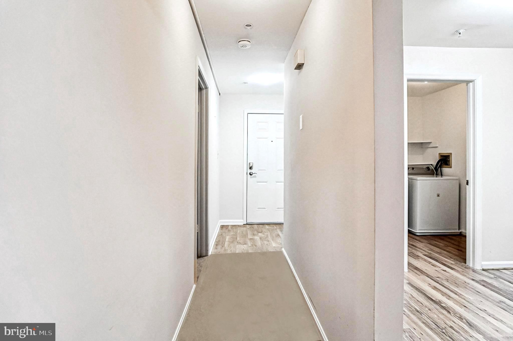 2900 Shipmaster Way, Unit 216 Annapolis, MD 21401 - Photo 11 of 53 Hallway Linking Kitchen and Great Room