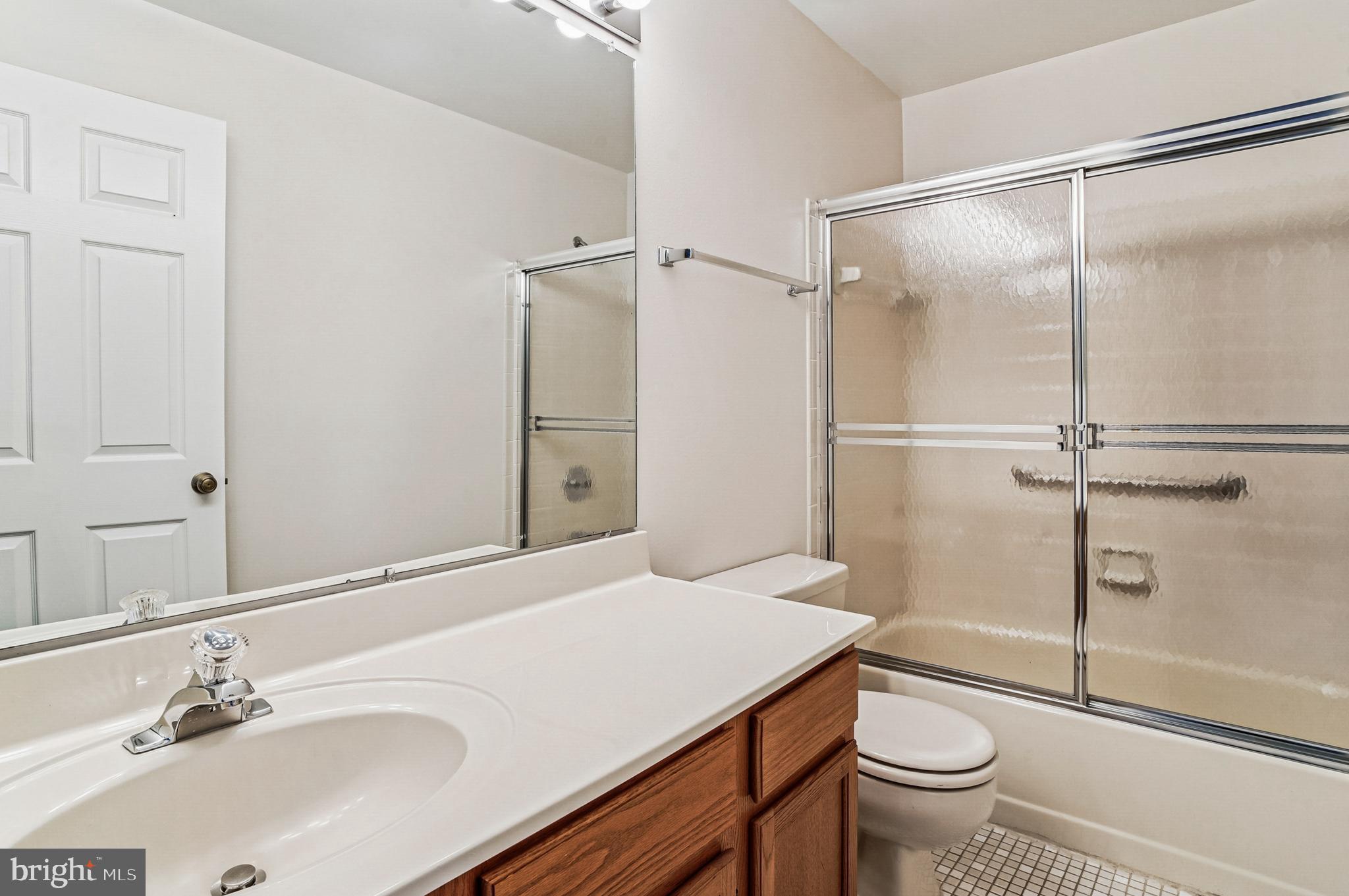 2900 Shipmaster Way, Unit 216 Annapolis, MD 21401 - Photo 28 of 53 Mirrored Vanity & Mosaic Tile Floor