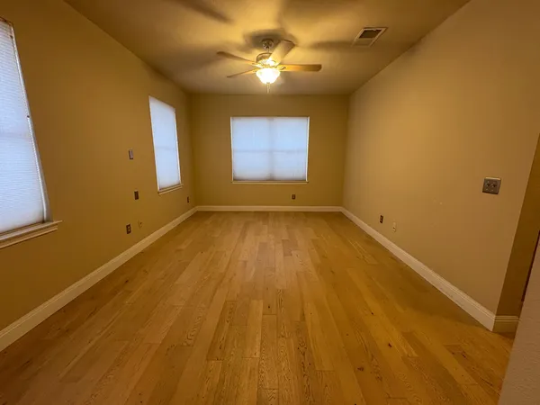 a view of room with window and ceiling fan