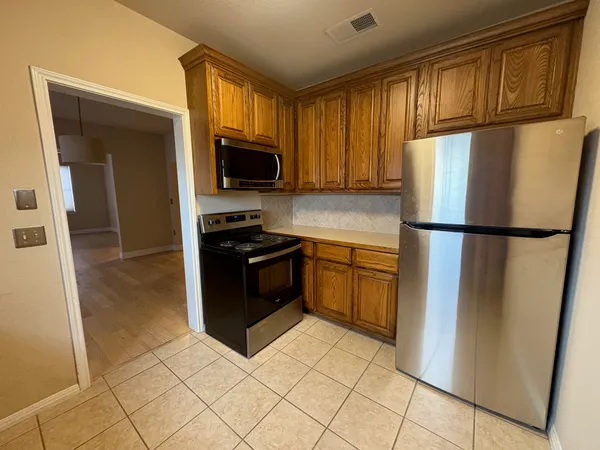 a kitchen with a refrigerator sink and microwave