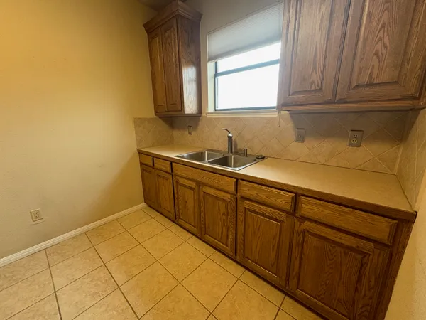 a view of a kitchen with sink and cabinets