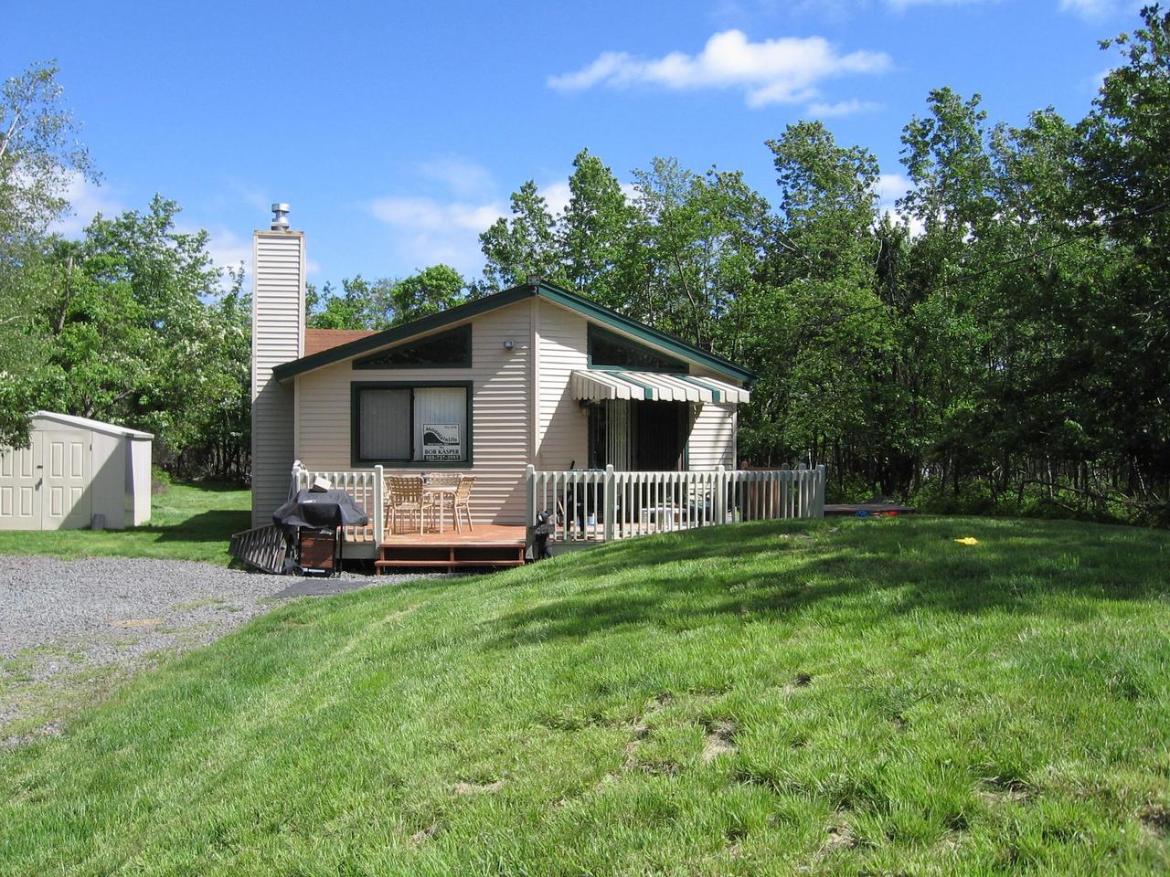 94 Winding Road Blakeslee, PA 18610 - Photo 1 of 1 a front view of a house with a yard and trees