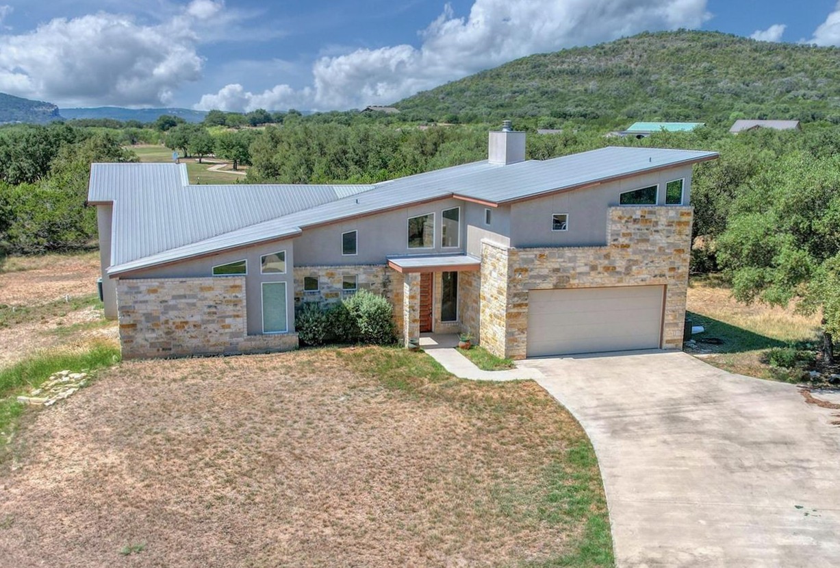 51 Starry Night Concan, TX 78838 - Photo 1 of 8 an aerial view of a house with a yard and garage