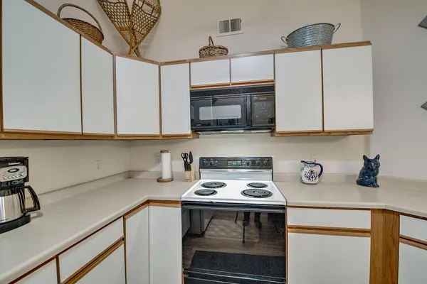 a kitchen with stainless steel appliances a stove a microwave and cabinets