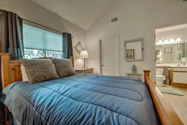 a bedroom with a large bed and a large window