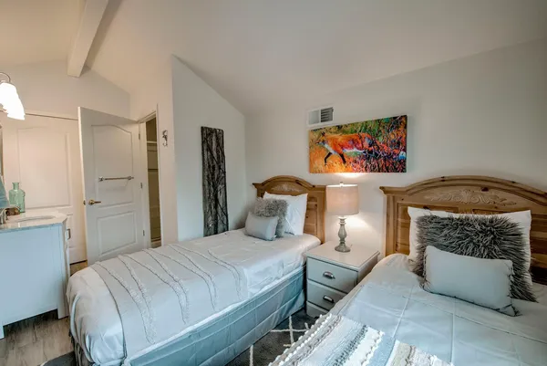 a bedroom with a bed a couch and dresser