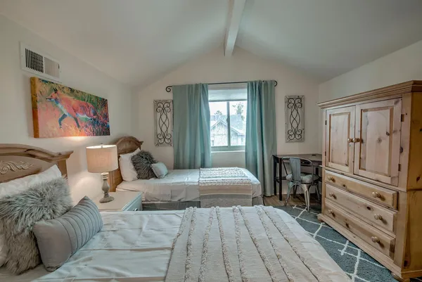 a bedroom with furniture and wooden floor