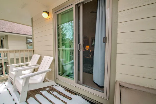 a view of two chairs in the balcony