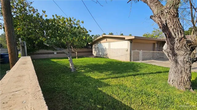 a view of a house with a yard