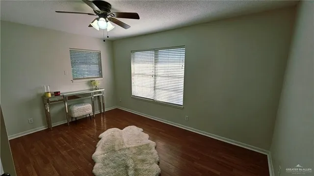 a view of livingroom with hardwood floor and ceiling fan