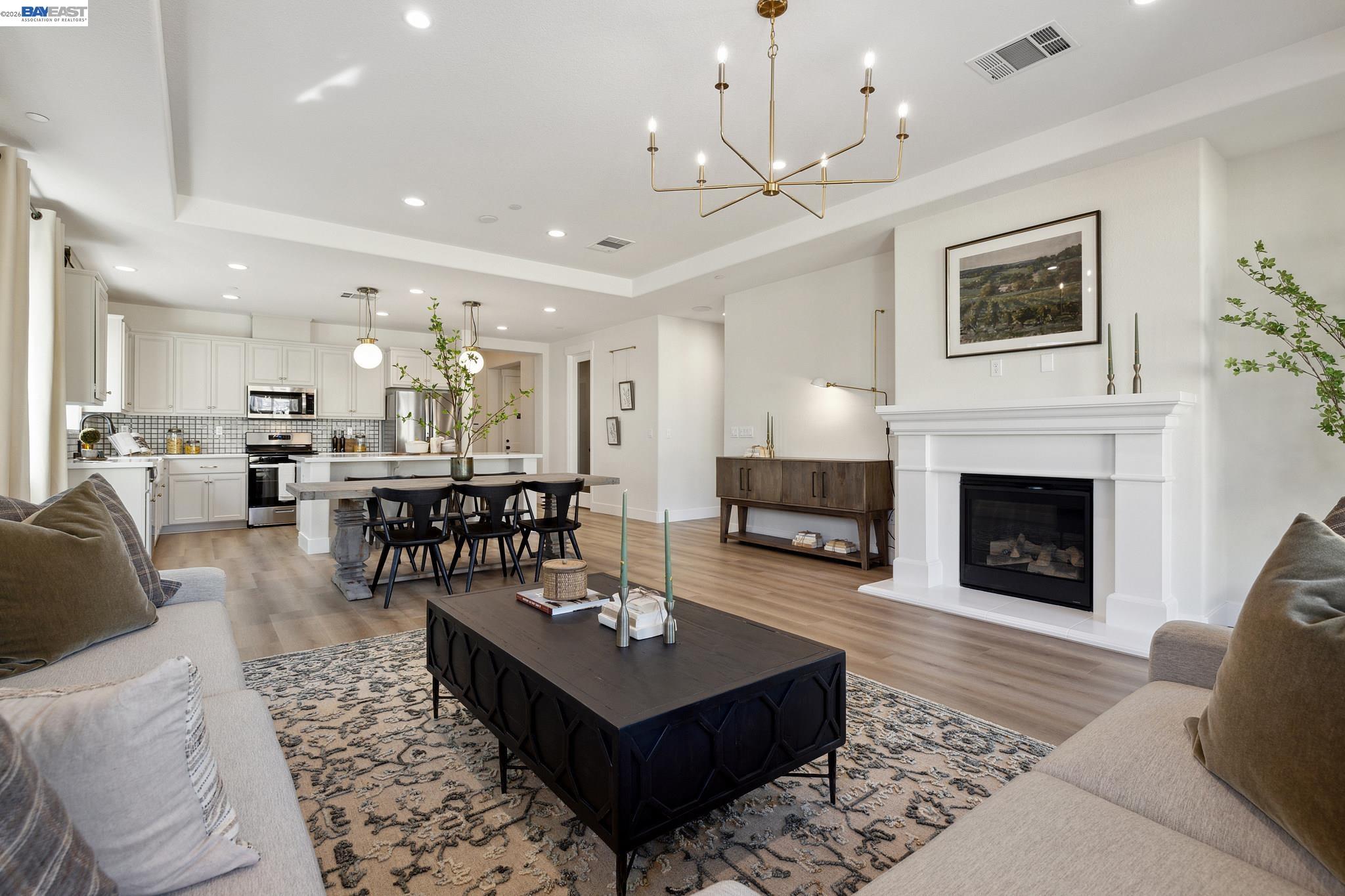 1504 Millennium Way Fairfield, CA 94533 - Photo 19 of 38 a living room with furniture a fireplace and a chandelier