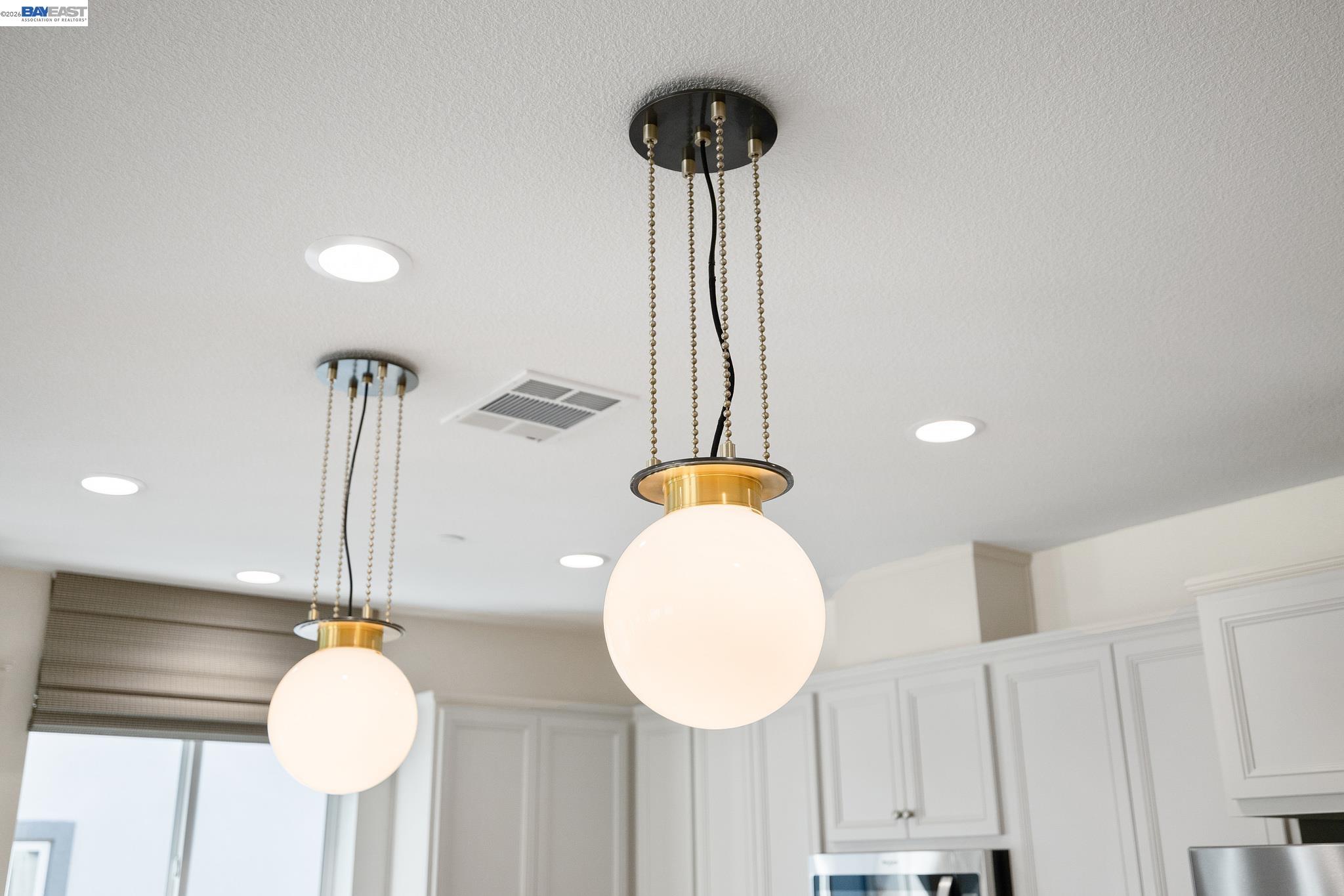 1504 Millennium Way Fairfield, CA 94533 - Photo 7 of 38 a lamp on a table with a chandelier and wooden floor