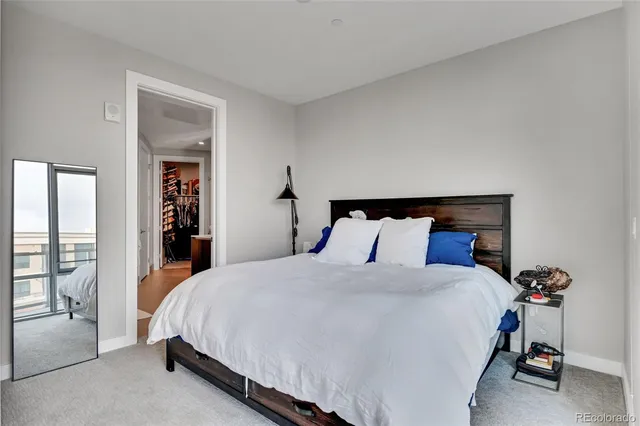 a bedroom with a bed and large mirror