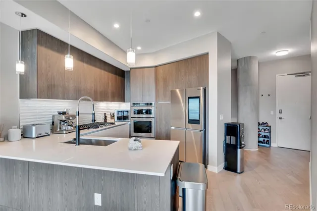 a kitchen with cabinets and stainless steel appliances