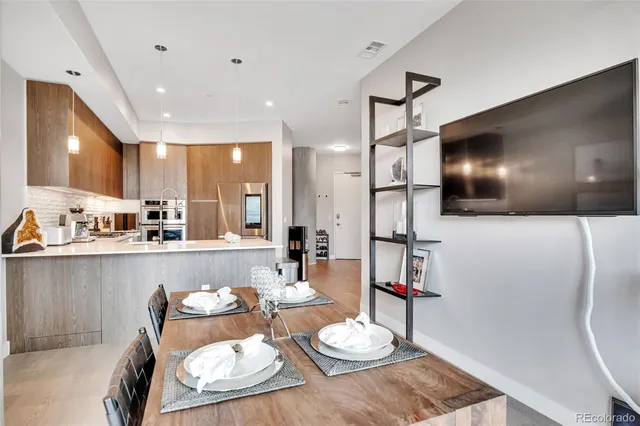 a kitchen with stainless steel appliances kitchen island granite countertop a sink and cabinets