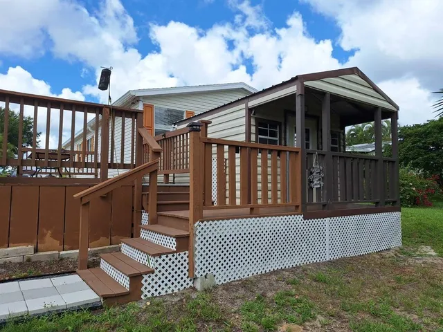 a view of a house with wooden fence
