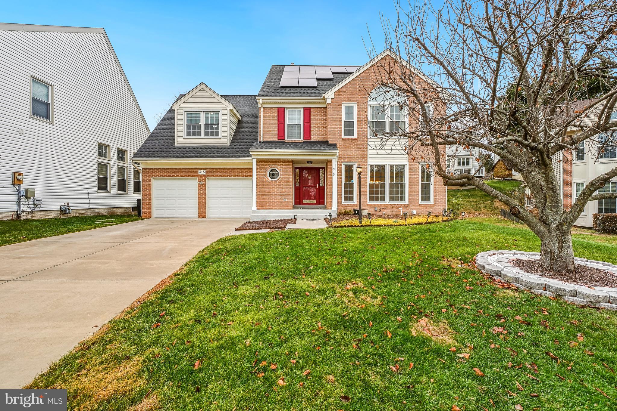 315 Argosy Drive Gaithersburg, MD 20878 - Photo 1 of 48 a front view of a house with a yard and trees