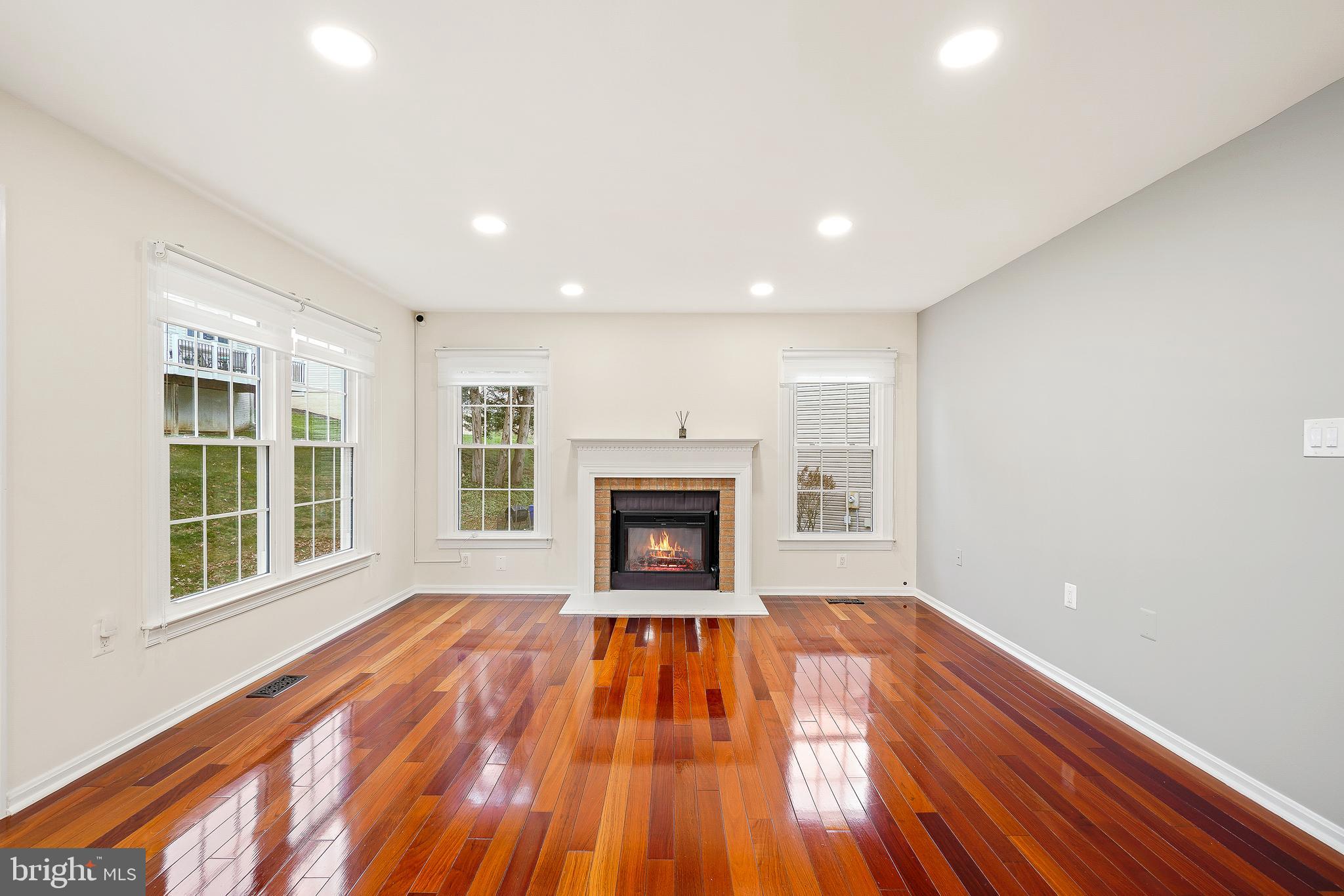 315 Argosy Drive Gaithersburg, MD 20878 - Photo 12 of 48 a view of an empty room with wooden floor fireplace and a window