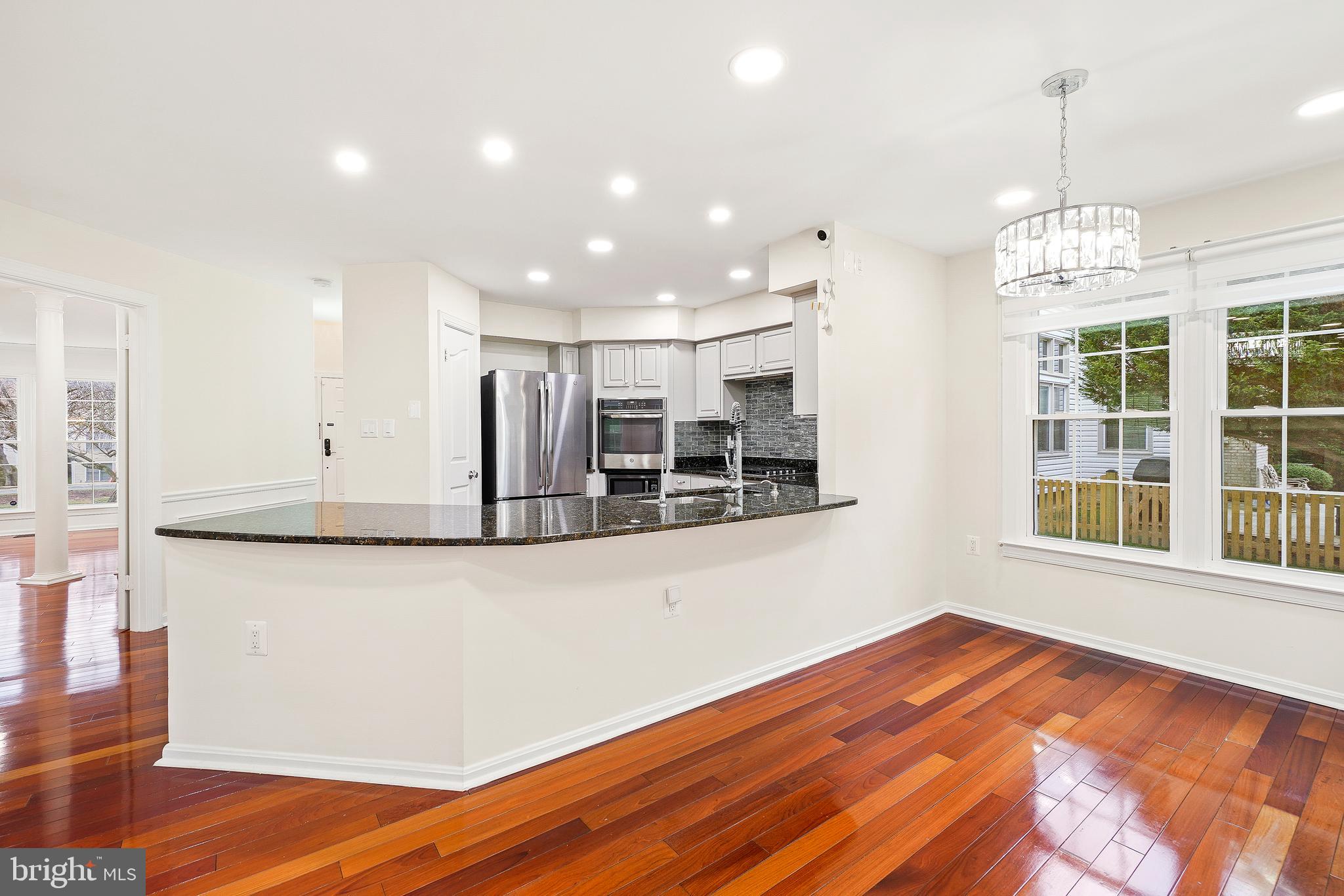 315 Argosy Drive Gaithersburg, MD 20878 - Photo 16 of 48 a view of a kitchen with wooden floor and windows