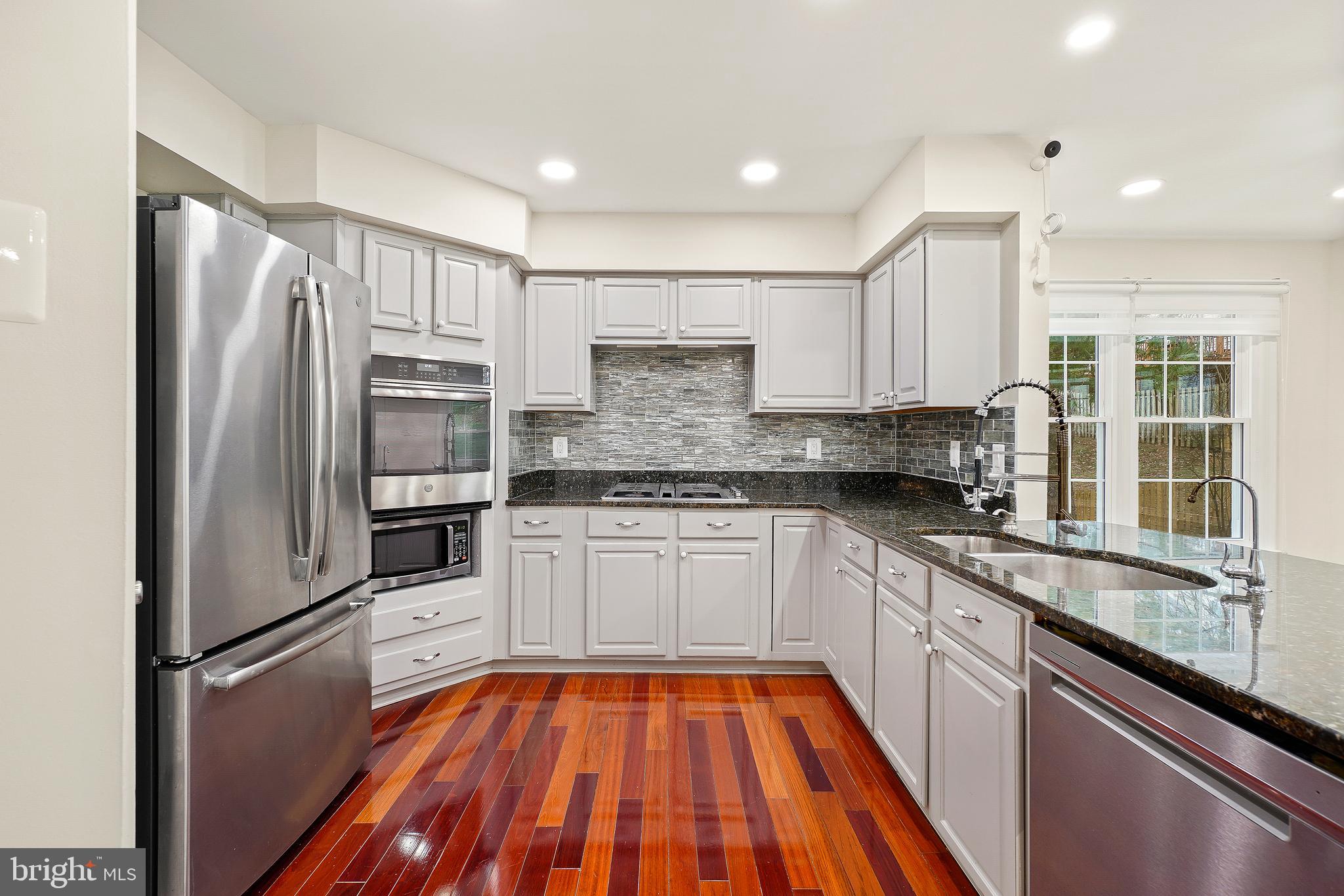 315 Argosy Drive Gaithersburg, MD 20878 - Photo 18 of 48 a kitchen with stainless steel appliances granite countertop a refrigerator and a sink