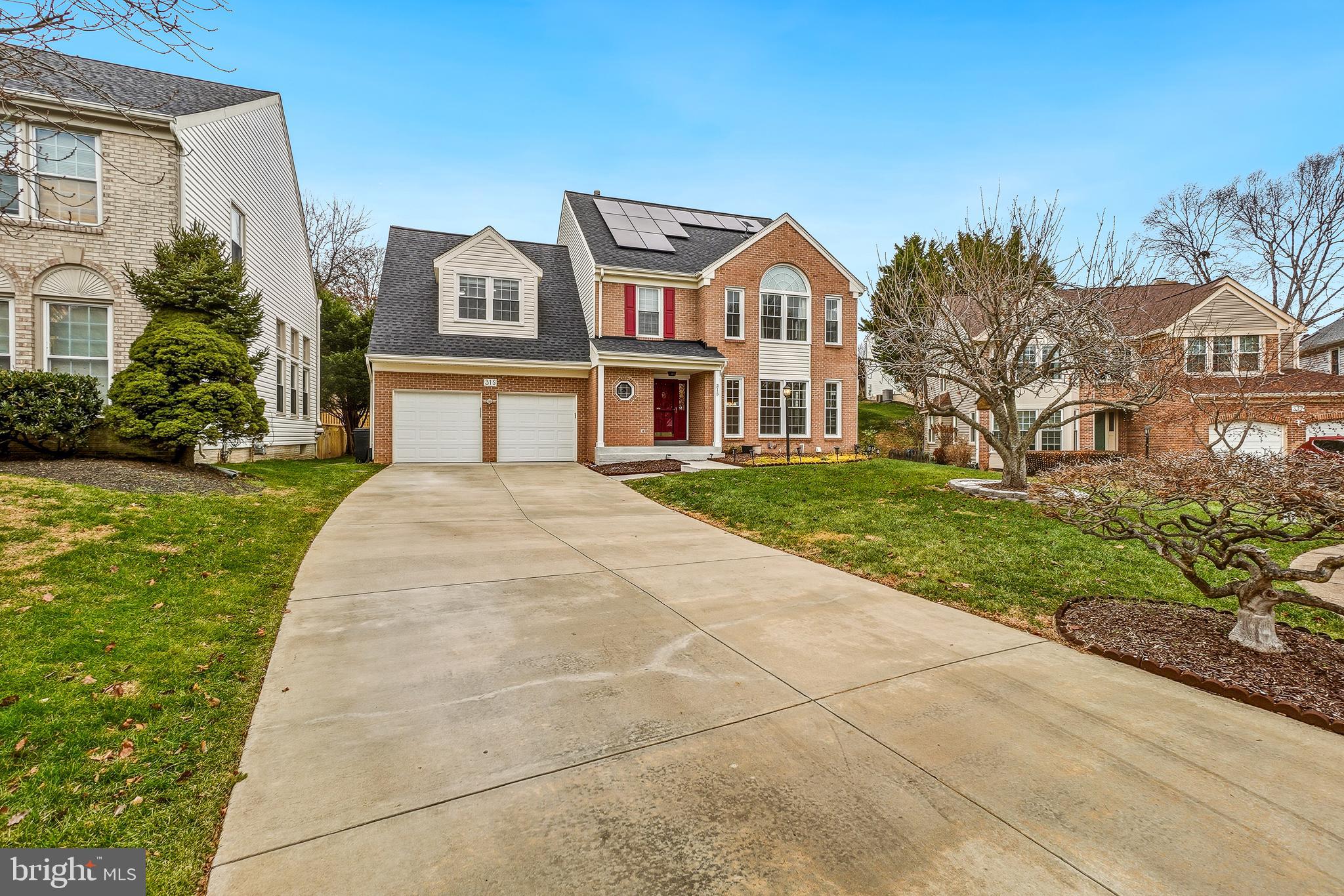 315 Argosy Drive Gaithersburg, MD 20878 - Photo 2 of 48 a front view of a residential apartment building with a yard