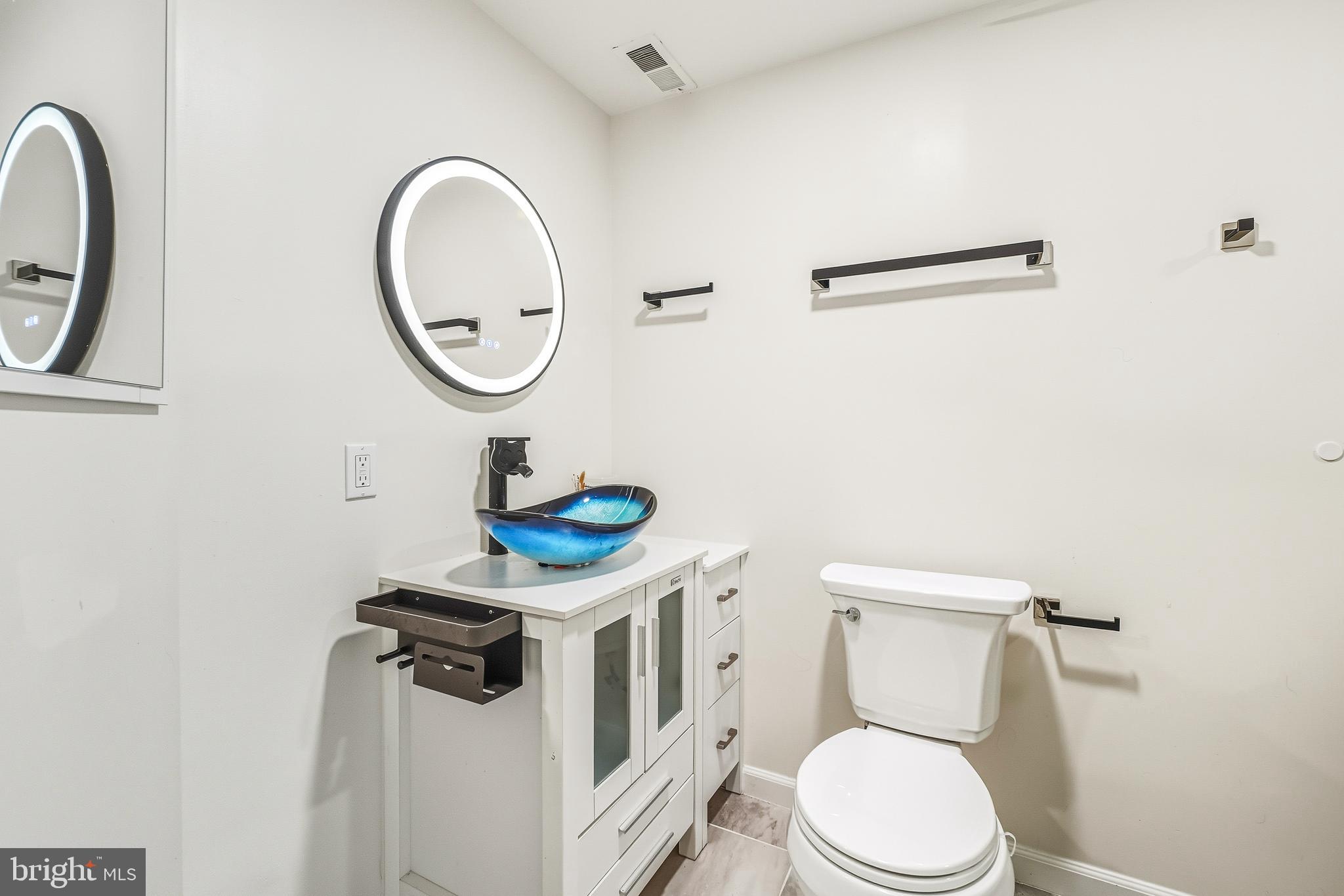 315 Argosy Drive Gaithersburg, MD 20878 - Photo 35 of 48 a white toilet sitting next to a bathroom sink