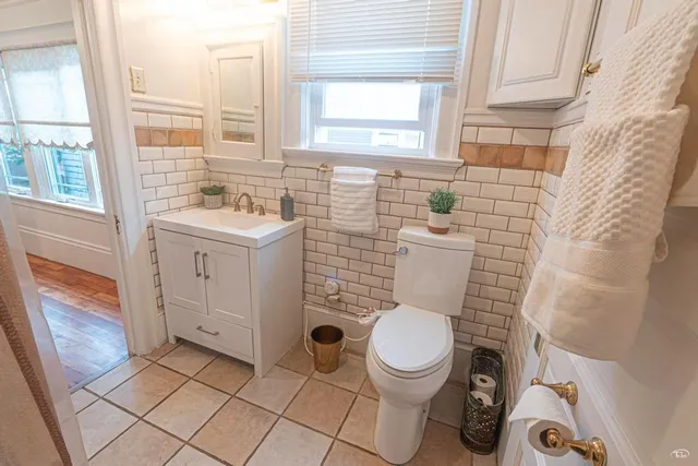 a bathroom with a sink a toilet and a shower curtain