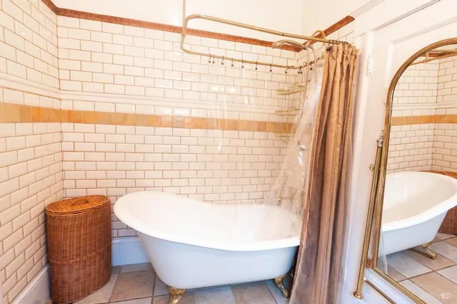 a bathroom with a bathtub and shower