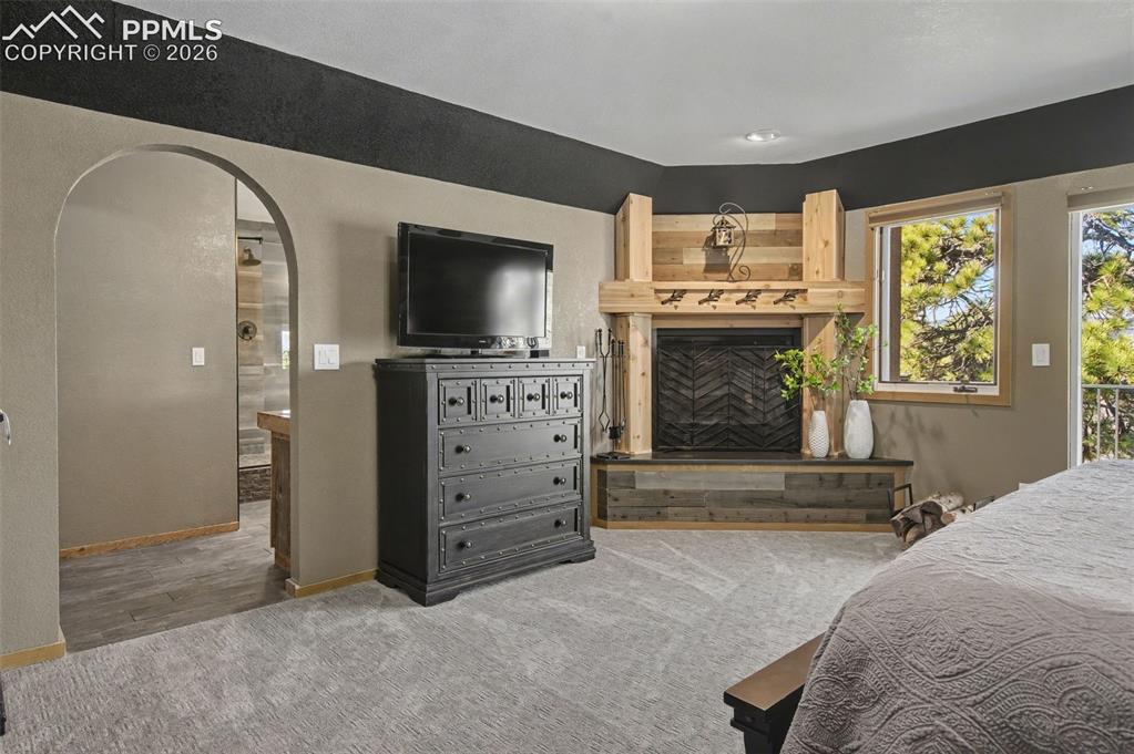 1375 Blueberry Hills Road Monument, CO 80132 - Photo 25 of 49 Primary Bedroom with cozy fireplace