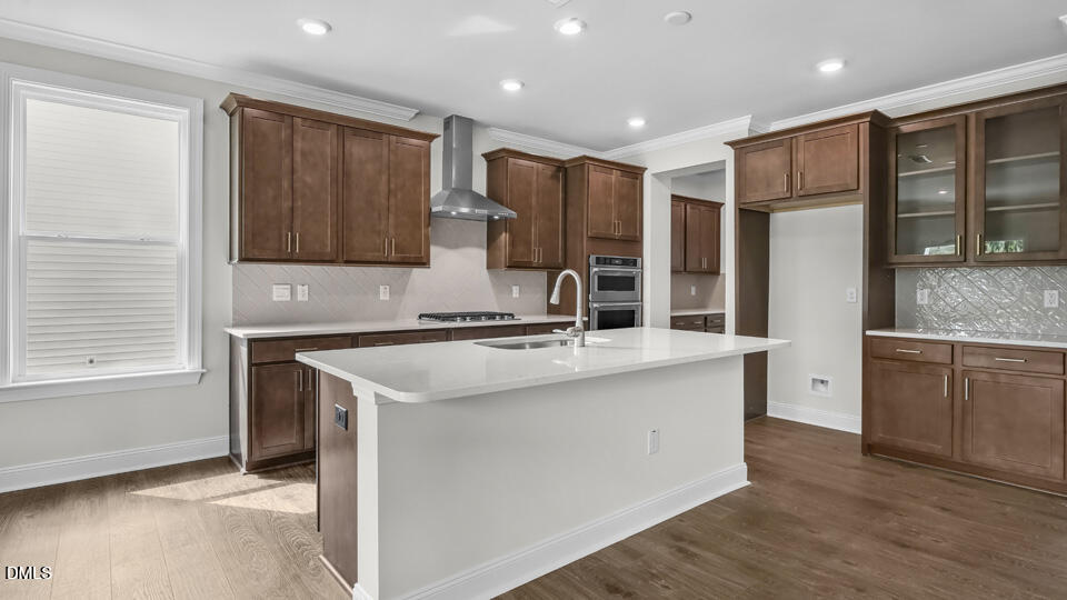 142 Red Jasper Way Clayton, NC 27520 - Photo 9 of 36 a kitchen with stainless steel appliances granite countertop a sink stove and refrigerator