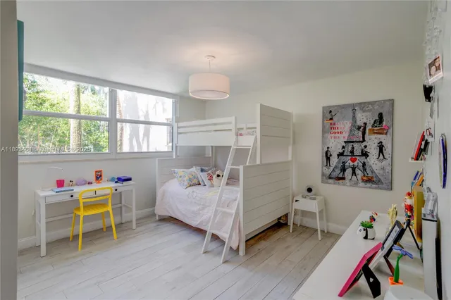 a bedroom with furniture and a wooden floor