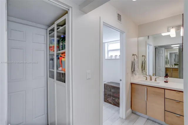 a bathroom with a shower sink and mirror