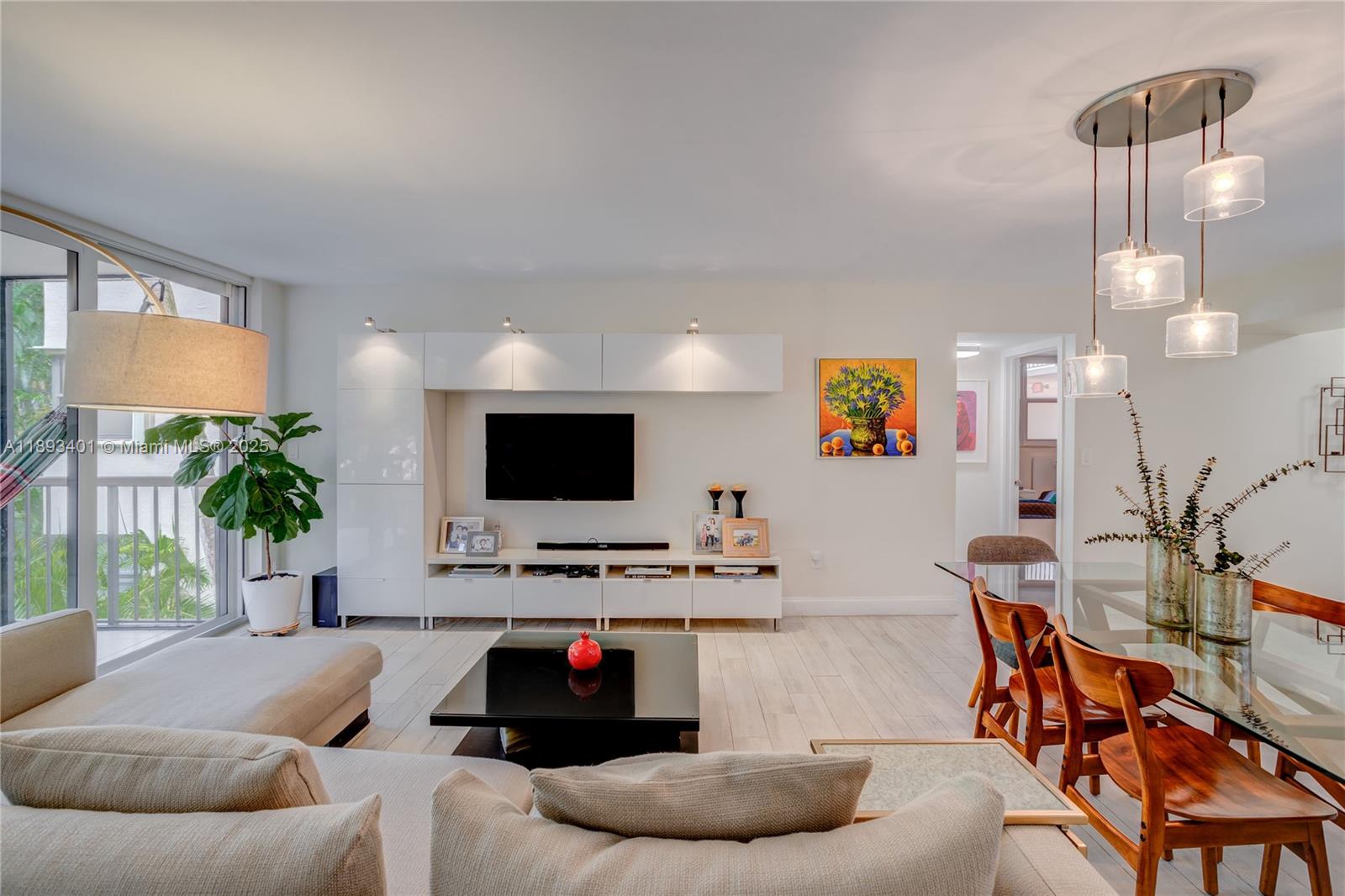 55 Ocean Ln Drive, Unit 2033 Key Biscayne, FL 33149 - Photo 3 of 21 a living room with furniture and a flat screen tv