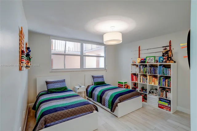 a bedroom with a bed and a book shelf