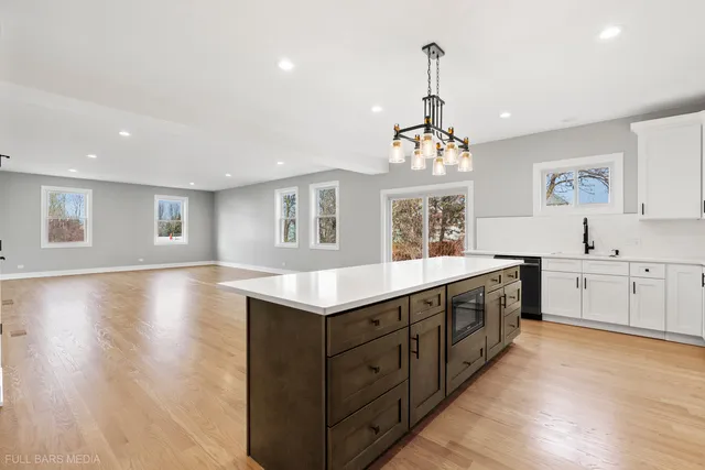 a kitchen with sink cabinets and wooden floor
