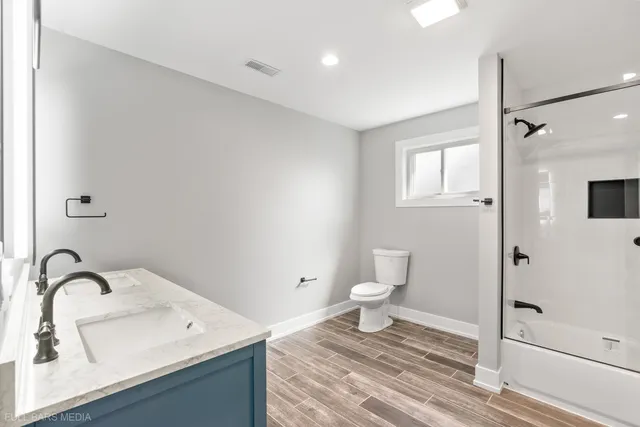 a bathroom with a sink toilet and shower