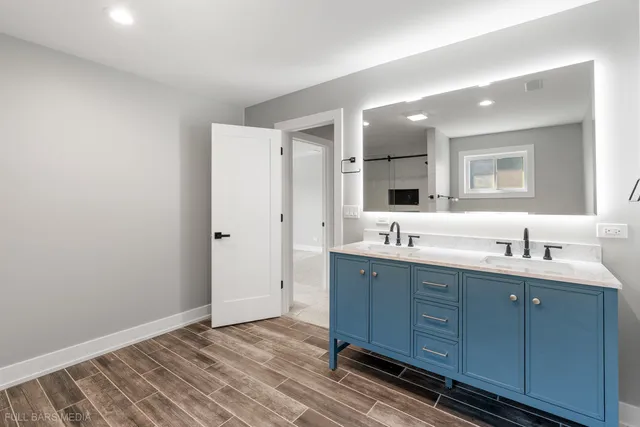 a bathroom with a double vanity sink and mirror