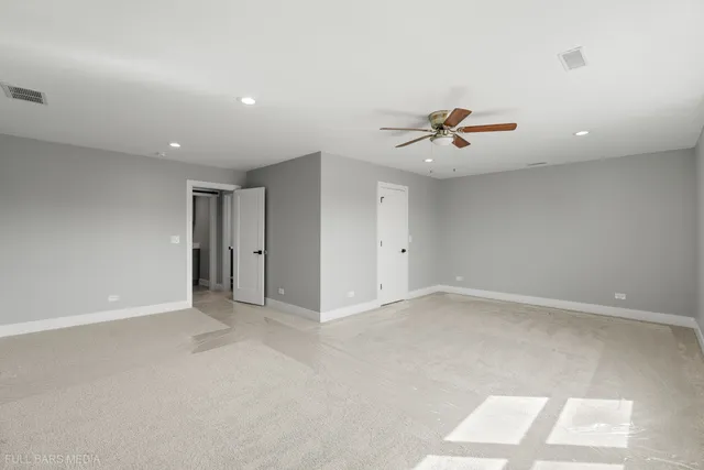 an empty room with fan and a ceiling fan