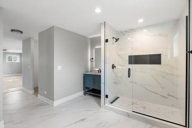 a bathroom with a shower and a glass door