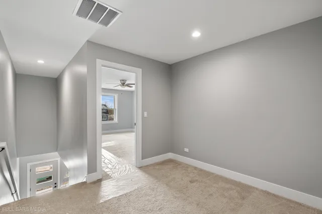 an empty room with a mirror and a door