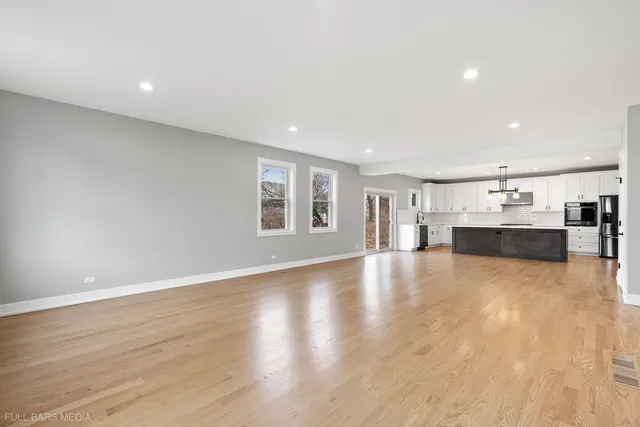 a view of kitchen with furniture and wooden floor