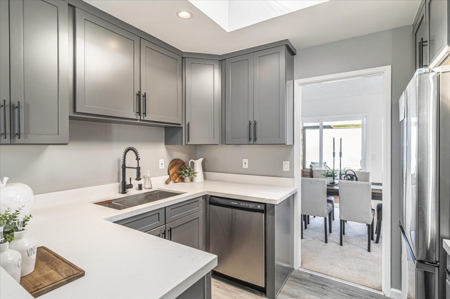 290 Beachview Avenue, Unit 39 Pacifica, CA 94044 - Photo 22 of 63 a kitchen with stainless steel appliances granite countertop a sink a stove and a refrigerator with wooden floor