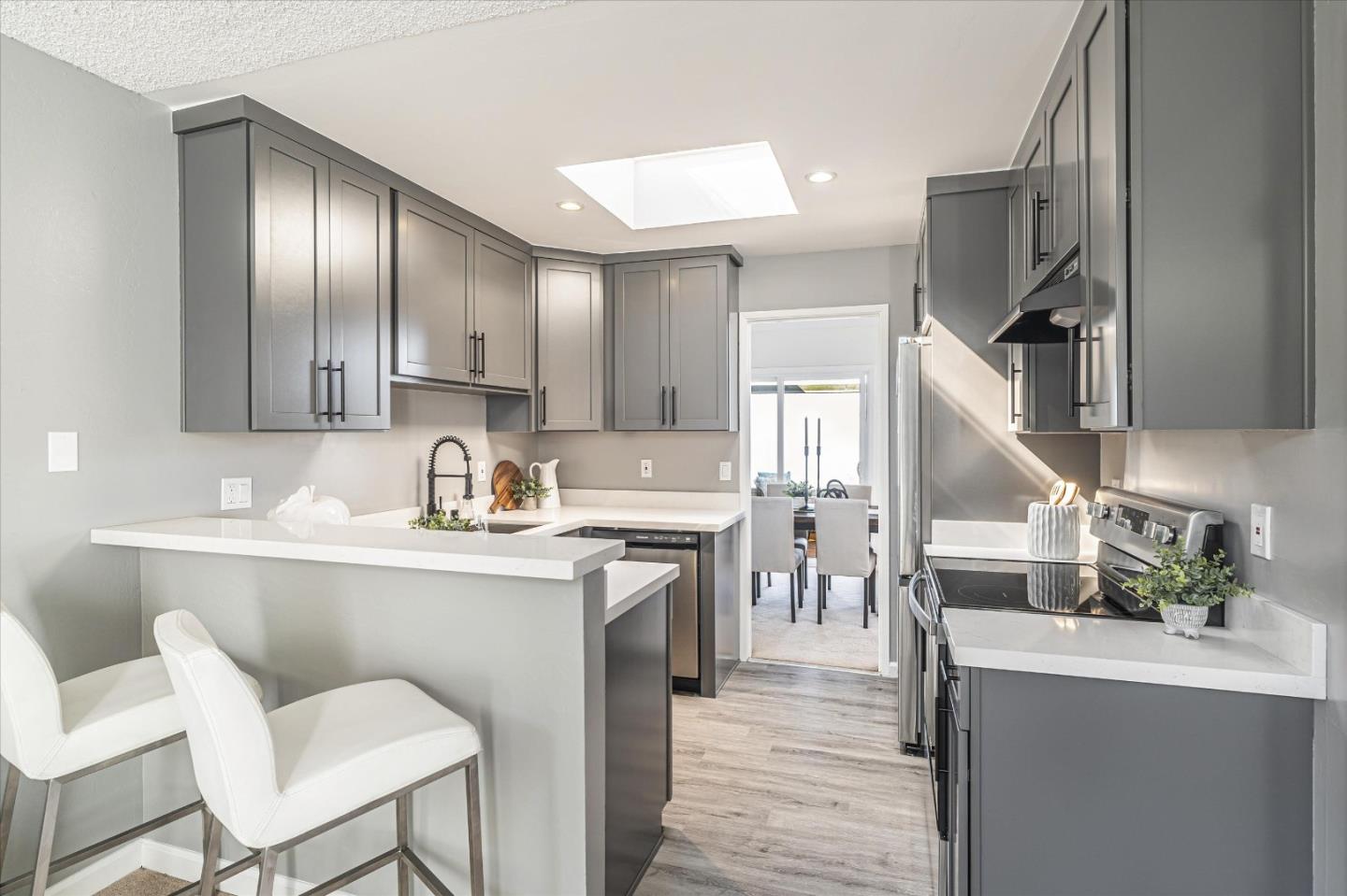 290 Beachview Avenue, Unit 39 Pacifica, CA 94044 - Photo 24 of 63 a kitchen with granite countertop cabinets a sink stainless steel appliances and wooden floor