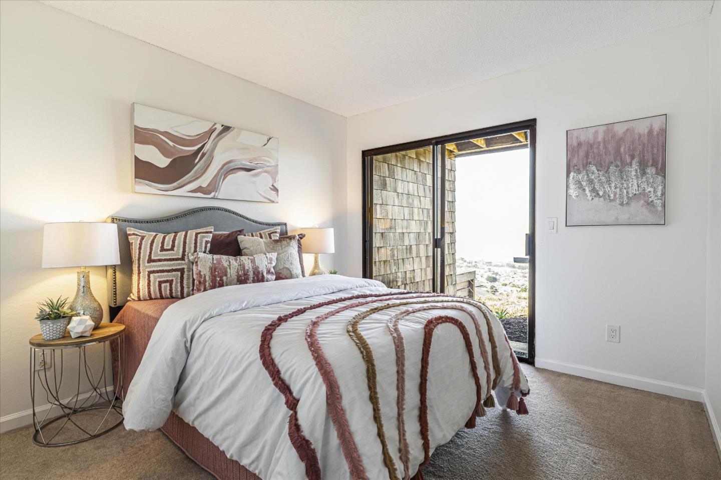 290 Beachview Avenue, Unit 39 Pacifica, CA 94044 - Photo 31 of 63 a bedroom with a bed and a painting on the wall