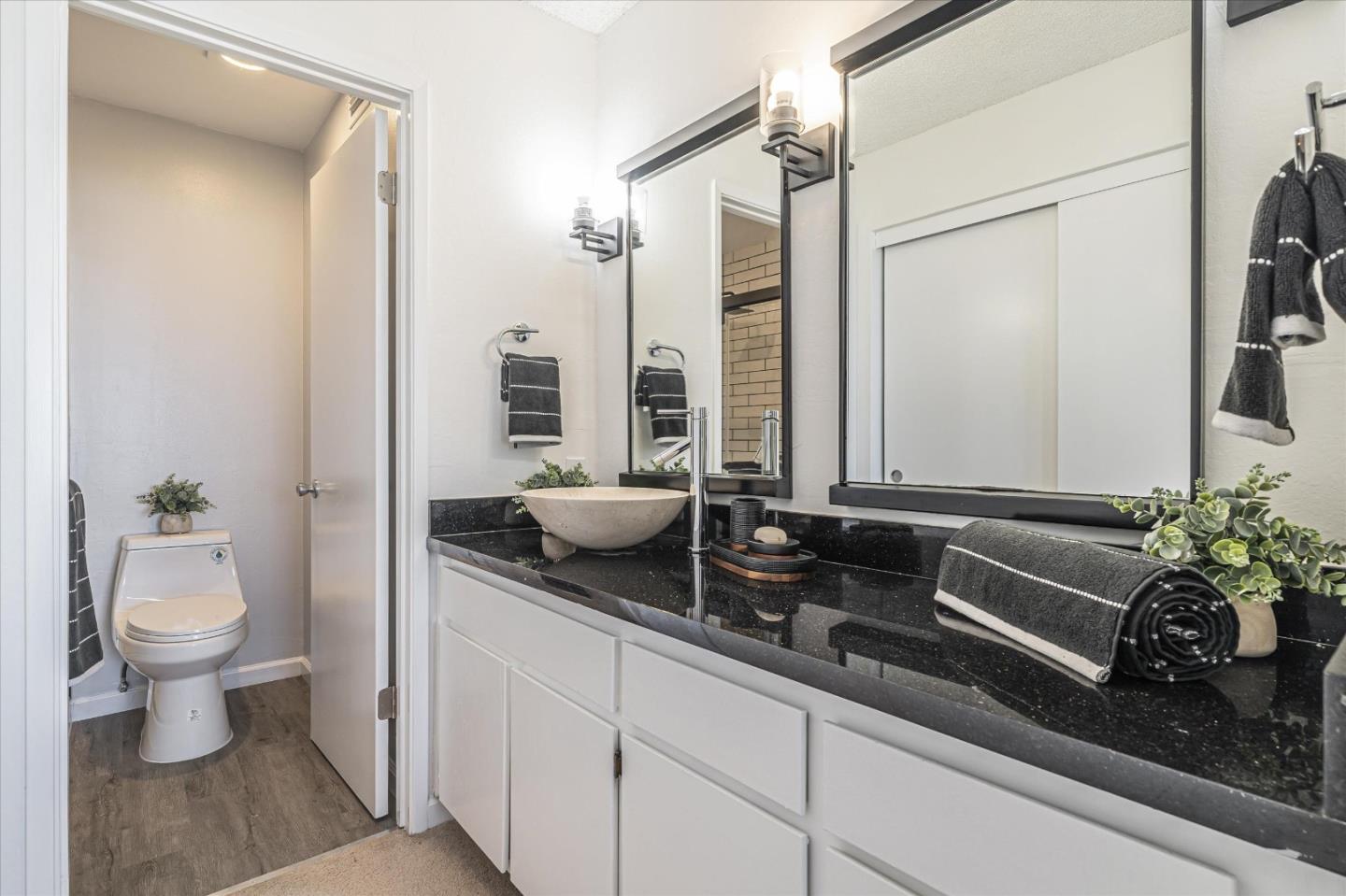 290 Beachview Avenue, Unit 39 Pacifica, CA 94044 - Photo 35 of 63 a bathroom with a granite countertop sink a toilet and a mirror