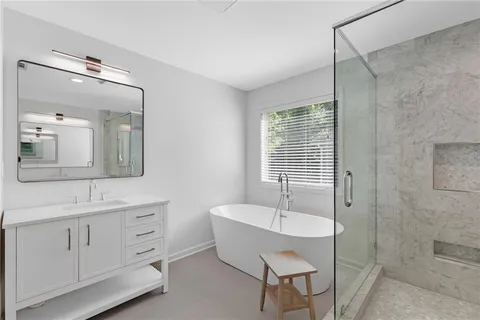 a spacious bathroom with a double vanity sink tub and mirror